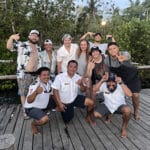 family and boat crew on dock